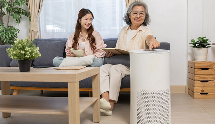 A young woman and an elderly woman sitting on a sofa