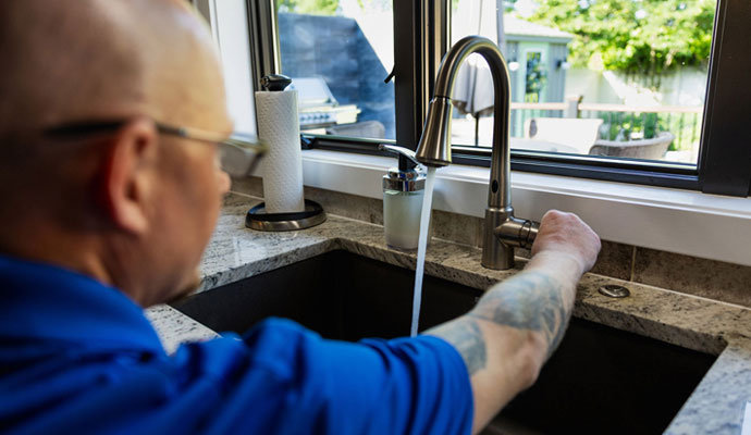 A professional inspecting basin tap